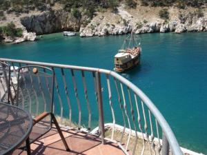 a boat in the water on a river at House Bernardica in Vrbnik