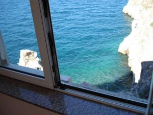 a view of the ocean from a window at House Bernardica in Vrbnik