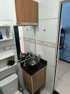 a small bathroom with a sink and a toilet at Casa mobiliada para Cop 30 in Ananindeua