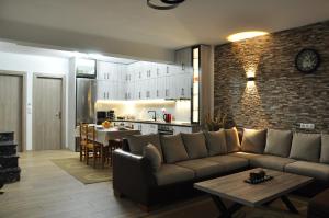 a living room with a couch and a table and a kitchen at Villa Oxana in Limenas