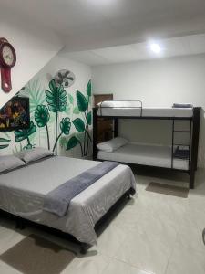 a bedroom with two bunk beds and a clock at Apartmento, Los Samanes in Roldanillo