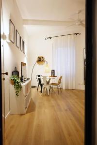 a living room with a table and a dining room at Cozy Stay in City Center in Livorno