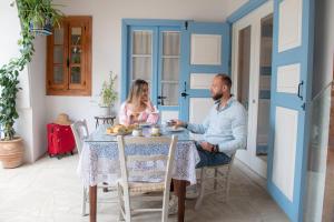 a man and a woman sitting at a table at 7Kamares in Pano Lefkara