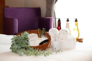 a basket of towels and toiletries on a bed at FIVE HOTEL OSAKA - Vacation STAY 10338v in Osaka