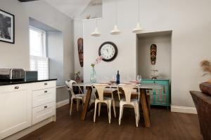 a kitchen and dining room with a table and chairs at Hide hill ,2 bedroom central apartment in Berwick-Upon-Tweed +10 photos