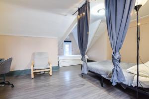 a bedroom with a canopy bed and a chair at Downtown Retreat-Spacious Rooms with Shared Kitchen & Bath in Toronto +5 photos