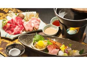 a table topped with a tray of food with sushi at Togen Kurobe UnazukiOnsen - Vacation STAY 04361v in Kurobe