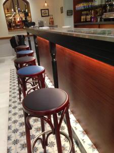 a row of stools at a bar in a restaurant at Hotel La Regence in Villefranche-sur-Mer
