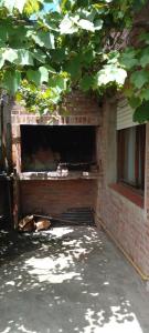 a brick building with a window and a brick fireplace at departamento en Valeria del mar in Valeria del Mar
