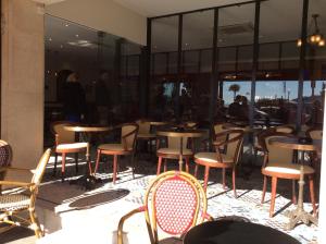 a group of tables and chairs in a restaurant at Hotel La Regence in Villefranche-sur-Mer