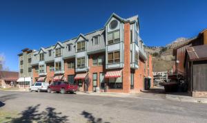 a large building with cars parked in front of it at One block walk to gondola, ski lockers downstairs, River Trail close by! in Telluride