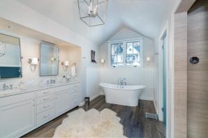 a white bathroom with a tub and a sink at Luxury at Miles High, with 2 Free Ski Passes in Telluride +18 photos