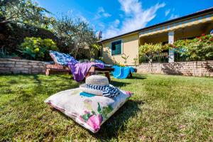 a blanket laying on the grass in a yard at Apartments and Rooms Villa Dea in Rovinj