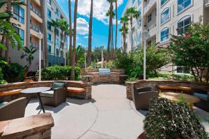 a courtyard with benches and tables in a building at Residence Inn Tampa Downtown in Tampa