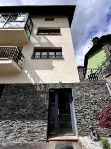 a house with a door and a brick wall at Apartamento La Massana Vistas in La Massana +33 photos