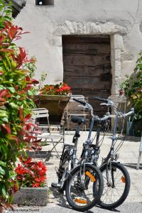 dos bicicletas estacionadas frente a un edificio con flores en Domaine Borgnat, en Escolives-Sainte-Camille