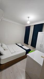 a bedroom with a bed and a desk in it at KARTALKAYA APART OTEL in Antalya +17 photos