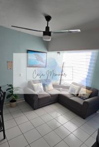 a living room with a couch in front of a window at Casa Memmar in Acapulco +24 photos