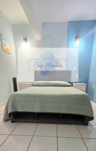 a bedroom with a bed with a sign on the wall at Casa Memmar in Acapulco