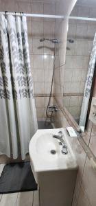 a bathroom with a sink and a shower at Casa Pino in Río Gallegos +18 photos