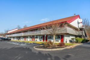 a building with a parking lot in front of it at HomeTowne Studios by Red Roof Danville, PA in Danville