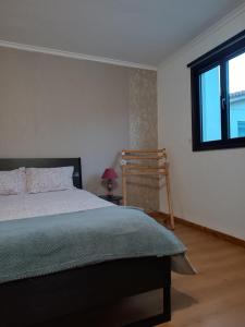 a bedroom with a bed and a window at O Canto do Melro, Guest House in Cortegaça +22 photos