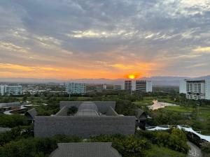 a sunset over a city with buildings and a building at 2 Bedroom Luxury Condo in Nuevo Vallarta 