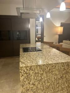 a kitchen with a granite counter top in a room at 2 Bedroom Luxury Condo in Nuevo Vallarta 