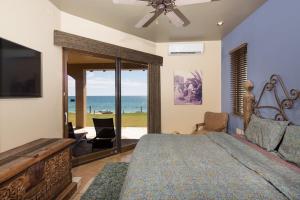 a bedroom with a bed and a view of the ocean at Villa Catalina at Bella Sirena - Private Jacuzzi - On the water in Puerto Peñasco