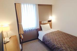a hotel room with a bed and a window at Marroad Inn Akasaka in Tokyo