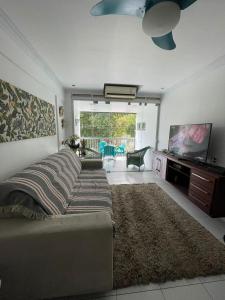 a living room with a bed and a flat screen tv at Apto Centro Belém Cop 30 Praça da República in Belém +23 photos