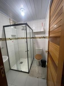 a bathroom with a toilet and a glass shower at Apto Centro Belém Cop 30 Praça da República in Belém