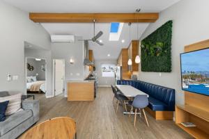 a living room and kitchen with a couch and a table at Modern Newly Renovated 2BR Apt in Heart of Ocean Beach in San Diego