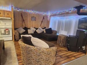 a living room with a couch and a television at Maison au Pied du Mont Video in Barraute +35 photos