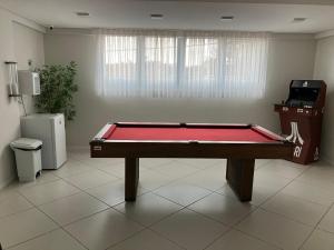 a ping pong table in a room with avertisement at Spot Miami in Araraquara +1 photo