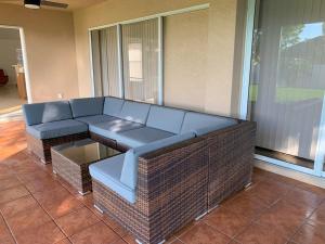 a living room with a couch and a table at The Elegant Suite in Shared House in Cape Coral