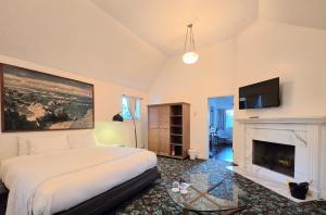 a bedroom with a bed and a fireplace at Dennen's Victorian Farmhouse in Little River