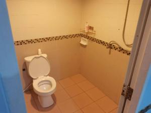 a bathroom with a toilet and a shower at 大叔的小屋 in Patong Beach