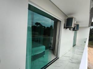 a glass door on the side of a building at Casa para temporada 2-Rio da ville in Porto Seguro