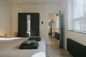 a bedroom with a bed with two pillows on it at 2 bedroom apartment near the city center in Liège