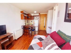 a living room with a couch and a kitchen at Metroapart 3 in Santiago