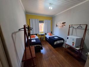 a small room with two beds in a room at Pousada uberaba in Uberaba
