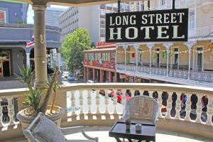 a balcony with a long street hotel sign and chairs at Long Street Boutique Hotel in Cape Town