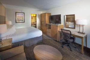 a hotel room with a bed and a desk at Best Western Plus Hilltop Inn in Redding +33 photos