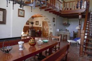 a living room with a wooden table and a dining room at Mas de Paco, Chimenea, barbacoa y piscina in Vall dʼAlba