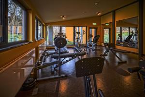 a gym with several treadmills and machines in a room at Wellnesshotel Schönblick - Superior in Eichstätt