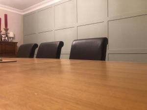 a conference room with a table and leather chairs at Gelilah House in Loughbrickland
