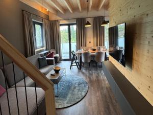 a living room with a couch and a table at modernes Chalet in Hahnenklee in Hahnenklee-Bockswiese
