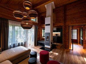 a living room with a couch and a chandelier at Lodge in Buntenbock in Flussnähe in Clausthal-Zellerfeld