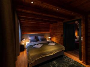 a bedroom with a bed in a room with wooden walls at Lodge in Buntenbock in Flussnähe in Clausthal-Zellerfeld +9 photos